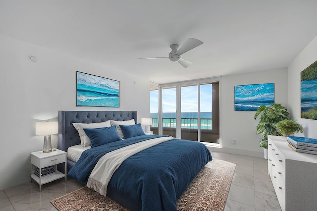 bedroom with a wall of windows, access to outside, and ceiling fan