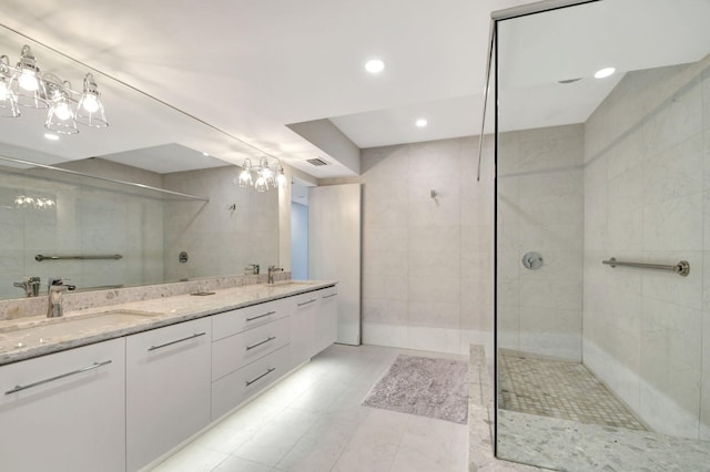 bathroom featuring vanity and tiled shower