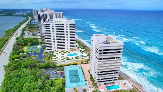 drone / aerial view with a beach view and a water view