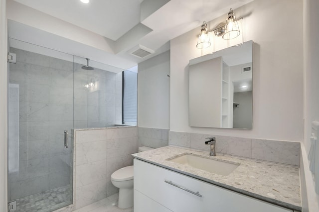 bathroom featuring an enclosed shower, vanity, toilet, and tile walls