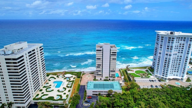 birds eye view of property featuring a beach view and a water view