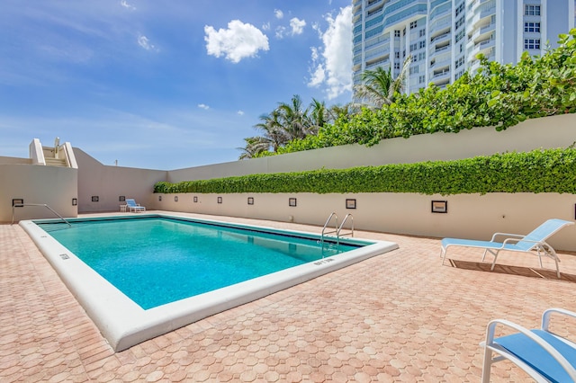 view of swimming pool with a patio area