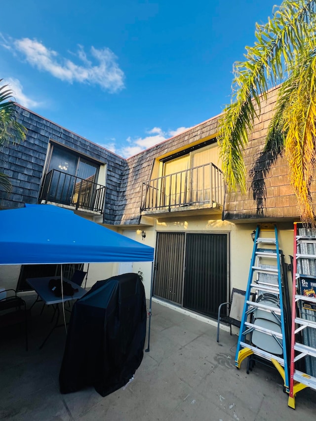 view of patio featuring a balcony