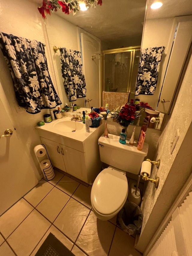 bathroom with walk in shower, tile floors, toilet, and oversized vanity