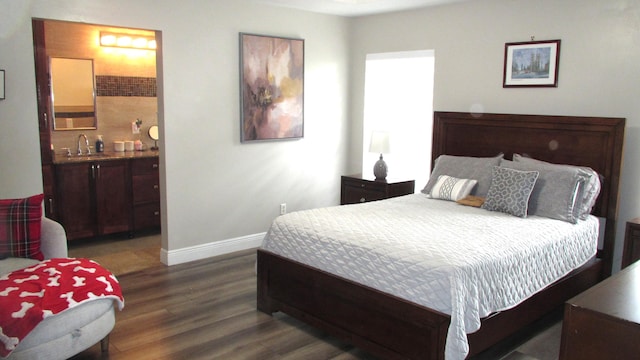 bedroom featuring sink and dark wood-type flooring