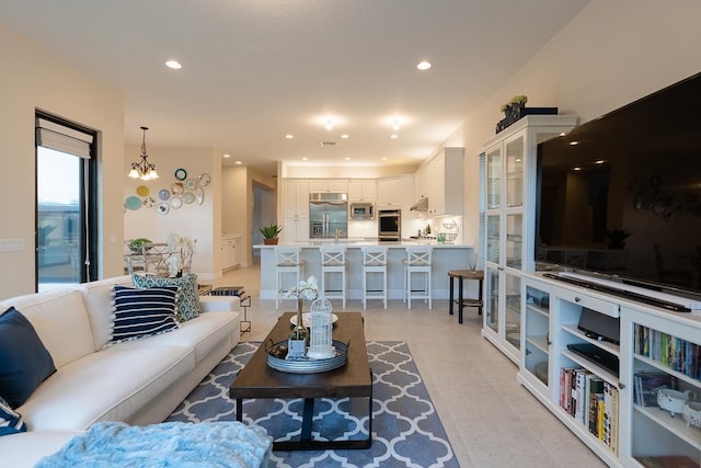 living room with an inviting chandelier and light tile patterned floors