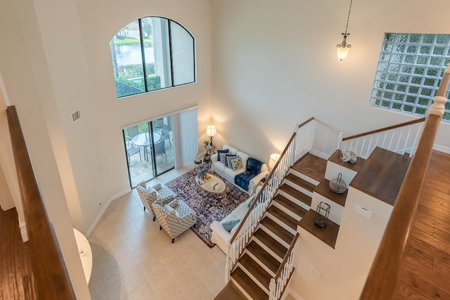 interior space featuring a high ceiling and tile patterned flooring