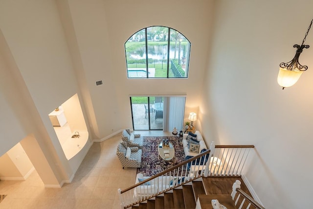 tiled living room with a high ceiling