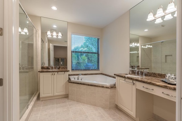 bathroom featuring plus walk in shower, tile patterned floors, and dual bowl vanity