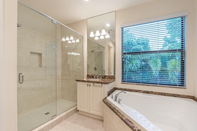 bathroom with tile patterned flooring, shower with separate bathtub, and vanity