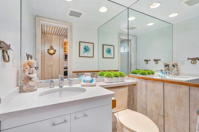 bathroom with toilet and vanity