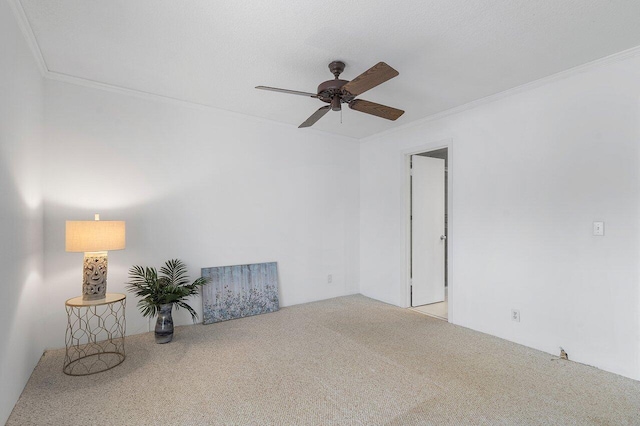 unfurnished room featuring light carpet, ceiling fan, and ornamental molding