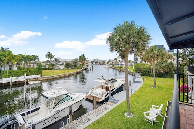 view of dock featuring a water view and a yard