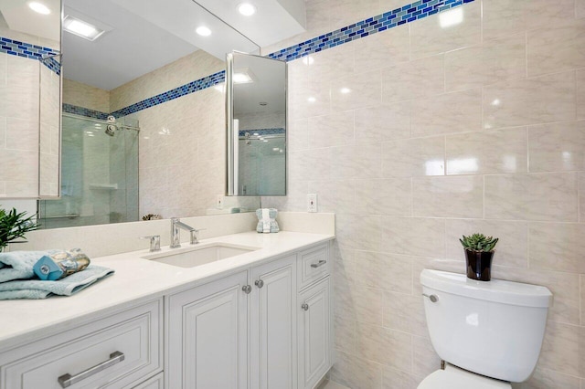 bathroom with toilet, tile walls, walk in shower, and vanity