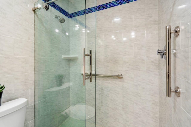 bathroom featuring an enclosed shower and toilet