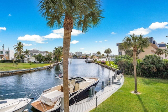 view of dock featuring a water view and a yard