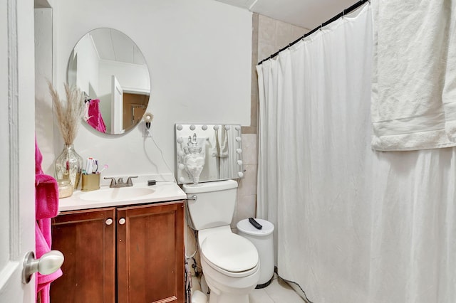 bathroom featuring oversized vanity, tile floors, and toilet