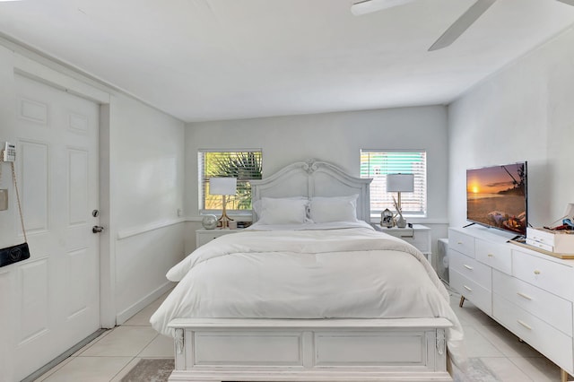 tiled bedroom featuring ceiling fan