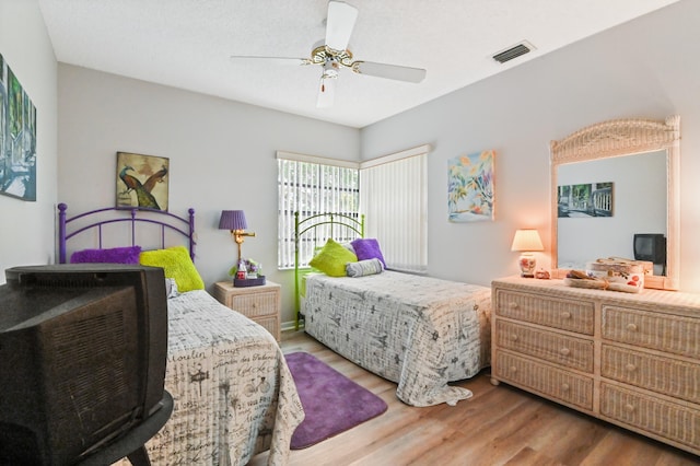 bedroom with ceiling fan and hardwood / wood-style flooring