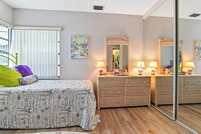 bedroom with a closet and light wood-type flooring