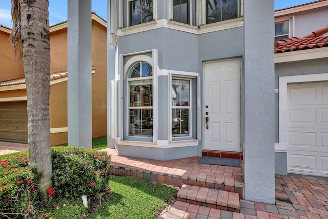 view of exterior entry featuring a garage