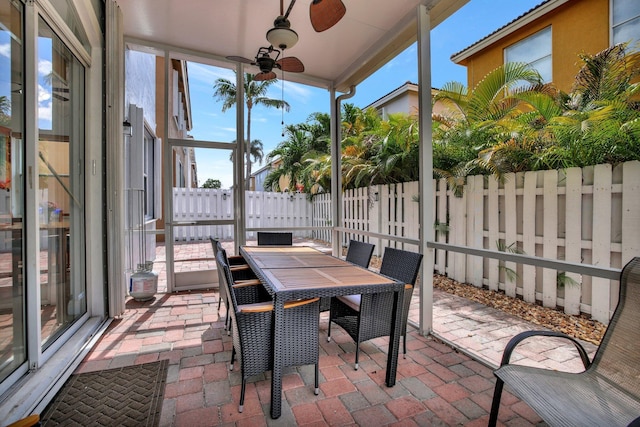 sunroom with ceiling fan and plenty of natural light