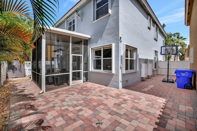 rear view of house with a patio and a sunroom