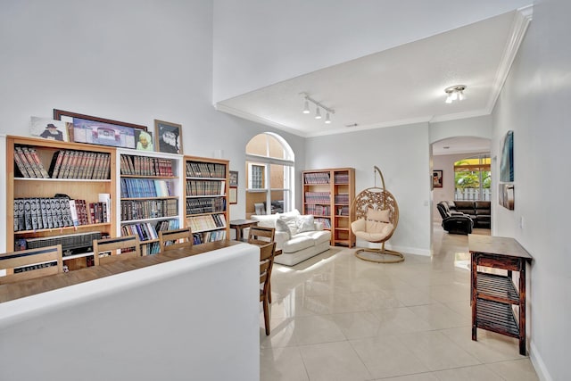 tiled living room featuring ornamental molding, a healthy amount of sunlight, and track lighting