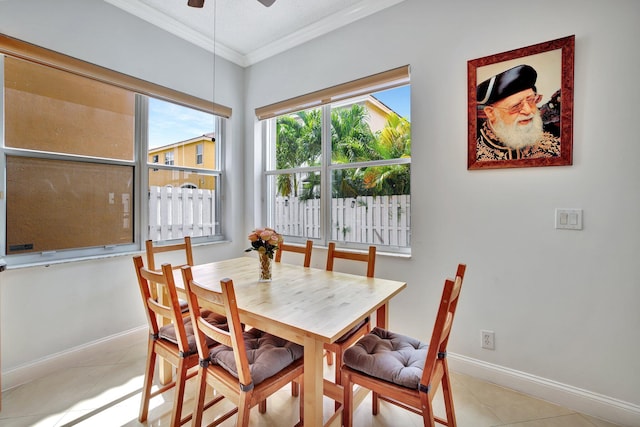 dining space with ornamental molding, ceiling fan, and light tile floors