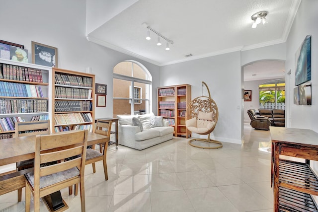 tiled living room with crown molding, track lighting, and a textured ceiling