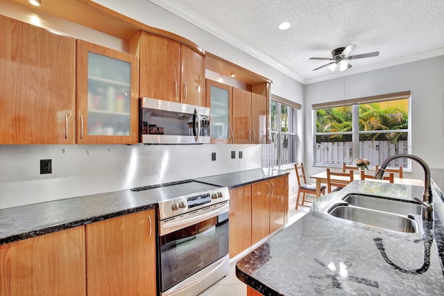 kitchen with range with electric stovetop, a textured ceiling, ceiling fan, and sink