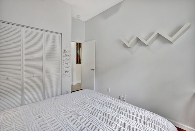 bedroom with a closet and a high ceiling