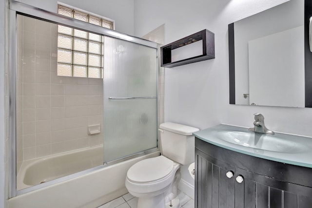 full bathroom with enclosed tub / shower combo, tile floors, toilet, and large vanity