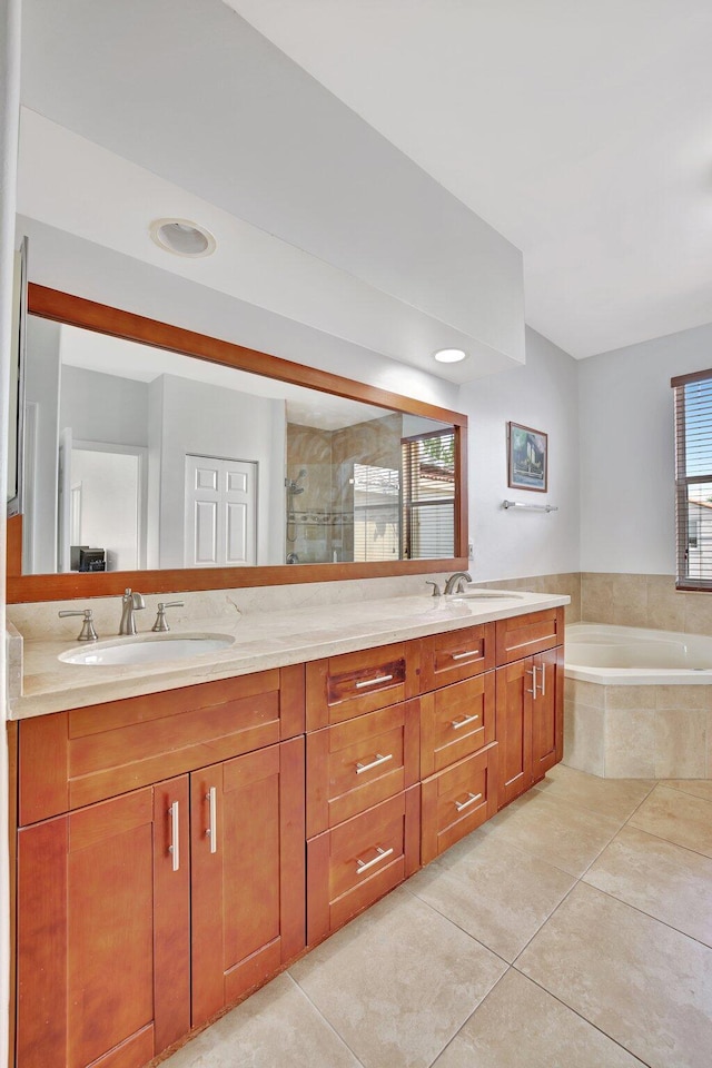 bathroom featuring tile flooring, large vanity, double sink, and tiled bath