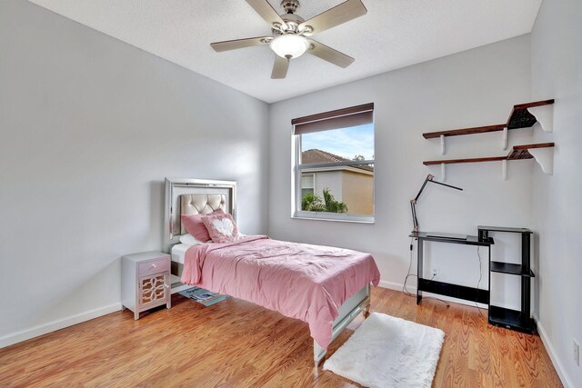 bedroom with ceiling fan and light wood-type flooring