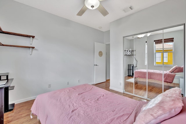 bedroom with a closet, wood-type flooring, and ceiling fan