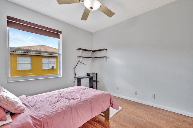 bedroom with wood-type flooring and ceiling fan