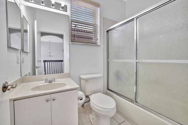 full bathroom with oversized vanity, bath / shower combo with glass door, toilet, and tile flooring