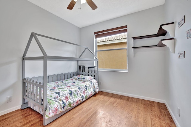 bedroom featuring light hardwood / wood-style floors and ceiling fan