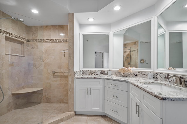 bathroom featuring vanity and tiled shower