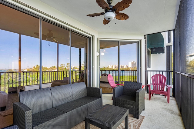 sunroom / solarium featuring a wealth of natural light and ceiling fan