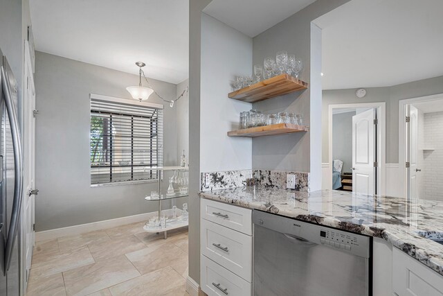 kitchen featuring light stone countertops, sink, decorative backsplash, white cabinets, and appliances with stainless steel finishes