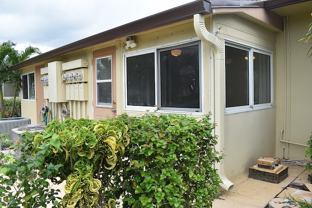 view of side of home featuring central AC