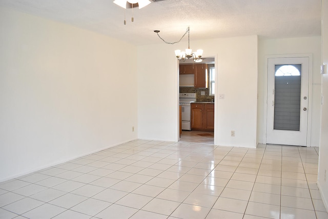 interior space featuring a textured ceiling and ceiling fan with notable chandelier