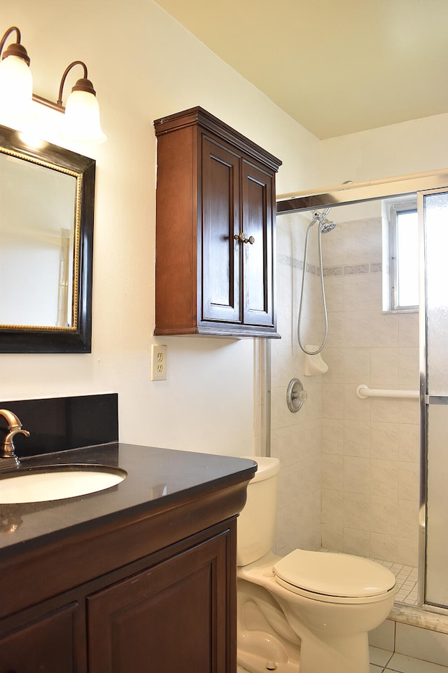 bathroom with toilet, an enclosed shower, vanity, and tile patterned flooring