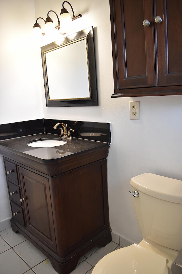 bathroom with vanity, toilet, and tile patterned flooring