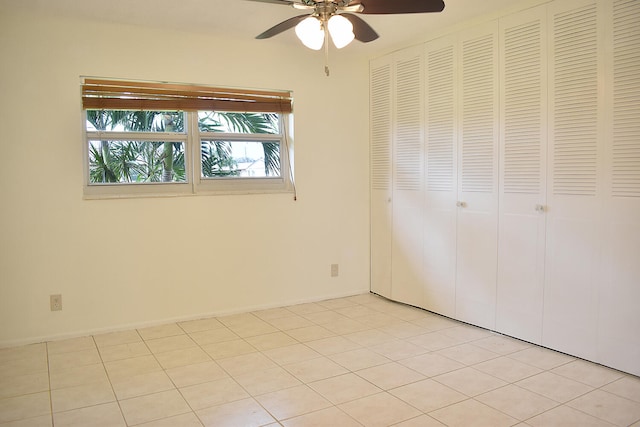 unfurnished bedroom featuring a closet, light tile patterned floors, and ceiling fan