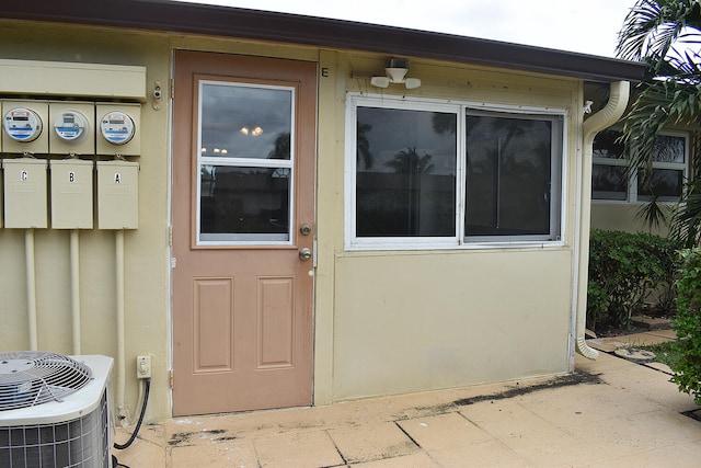 doorway to property featuring central air condition unit