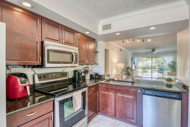 kitchen with ceiling fan, sink, crown molding, light tile patterned flooring, and appliances with stainless steel finishes