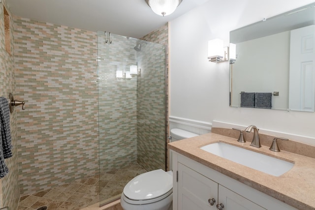 bathroom with vanity, toilet, and an enclosed shower